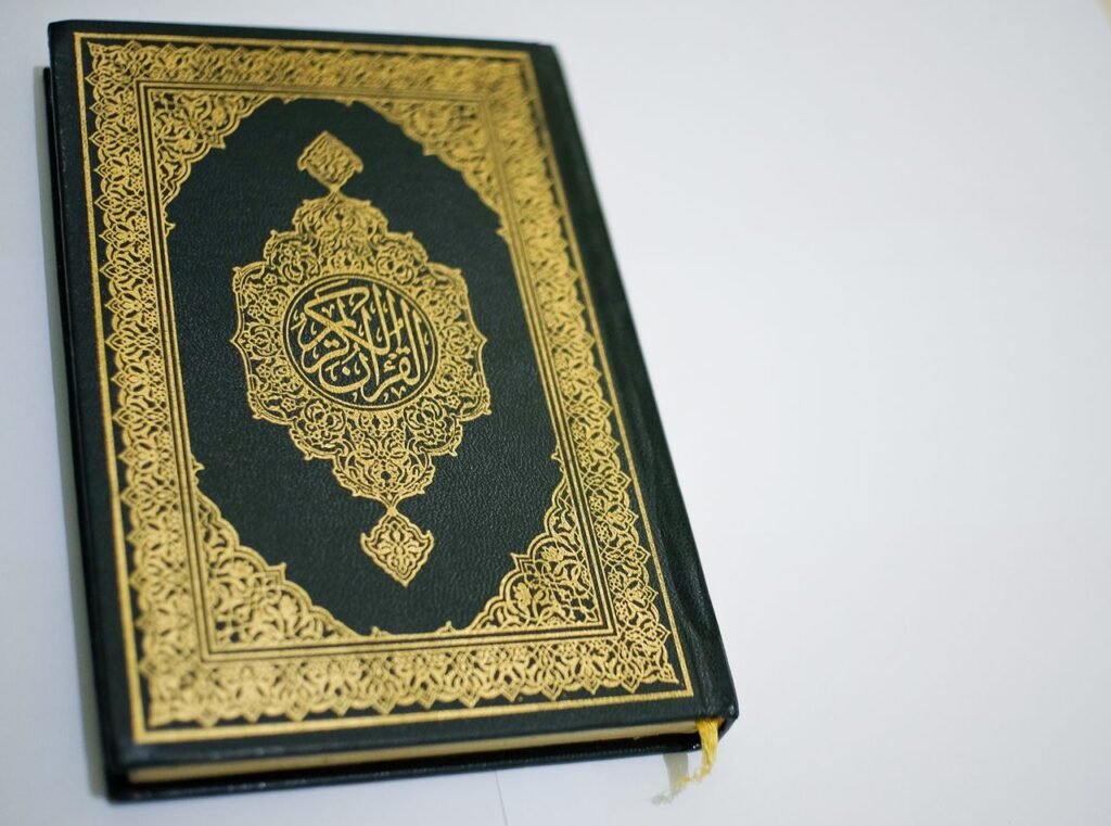 Stunning close-up of the Quran with intricate gold details on the cover, perfect for religious themes.