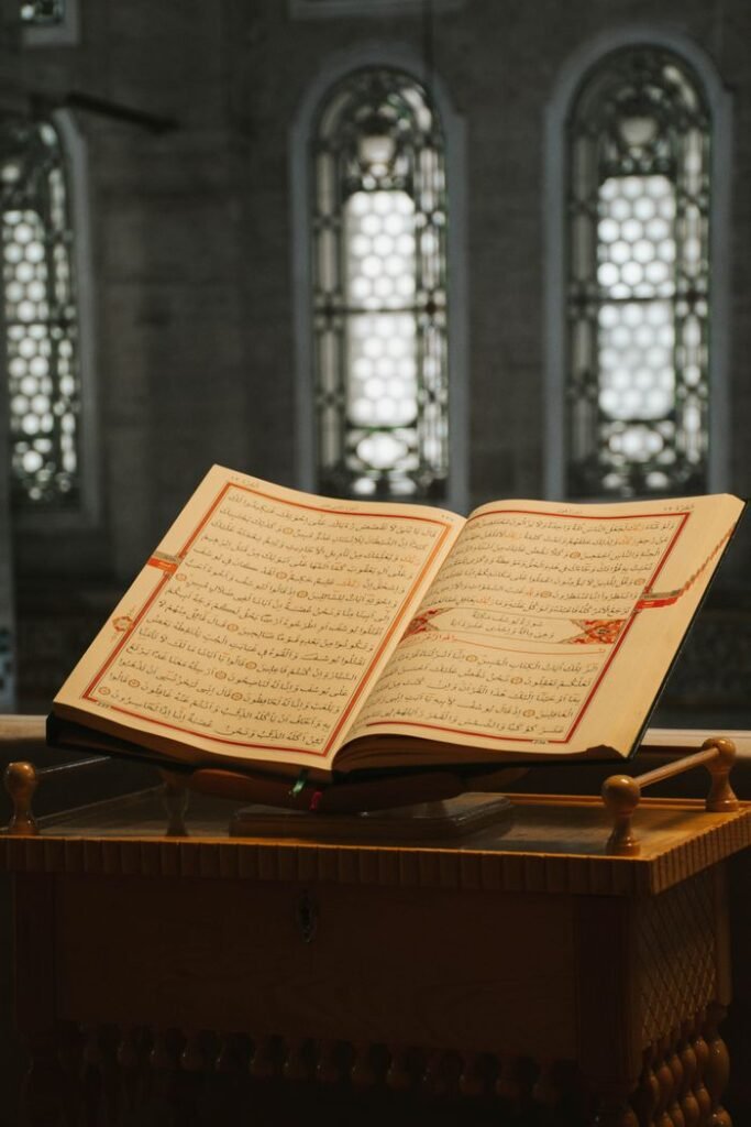 An open Quran on a wooden stand captures spiritual essence in a mosque.